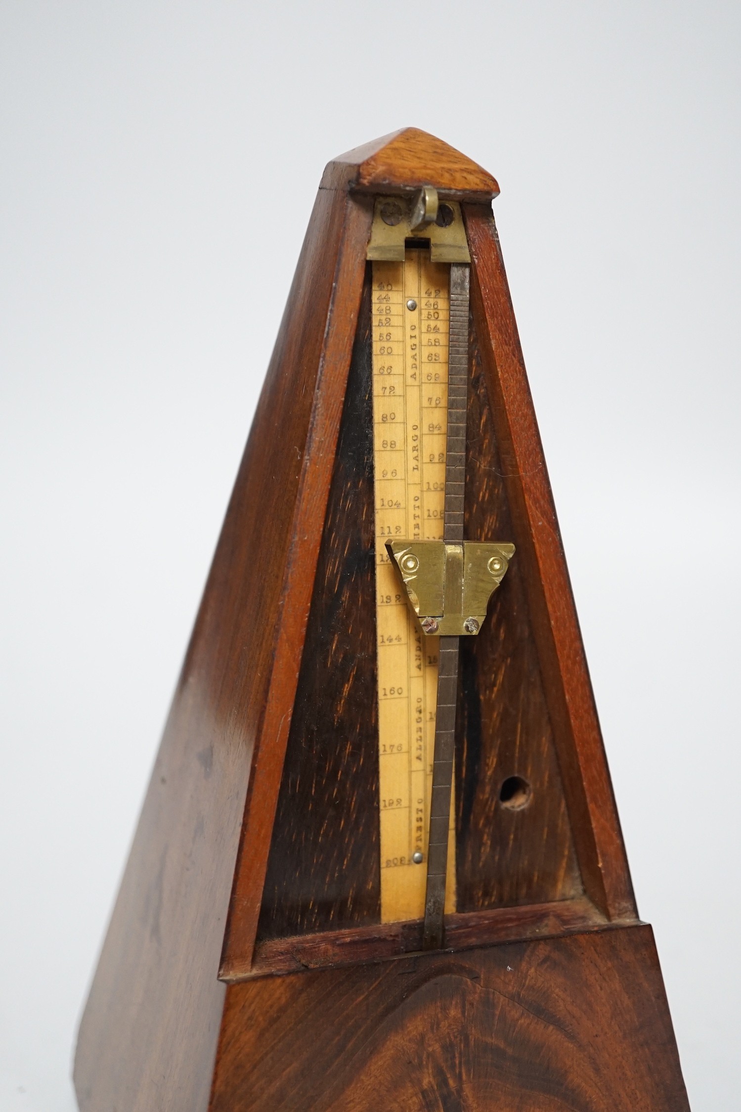 A 19th century mahogany metronome with key, 23ms high